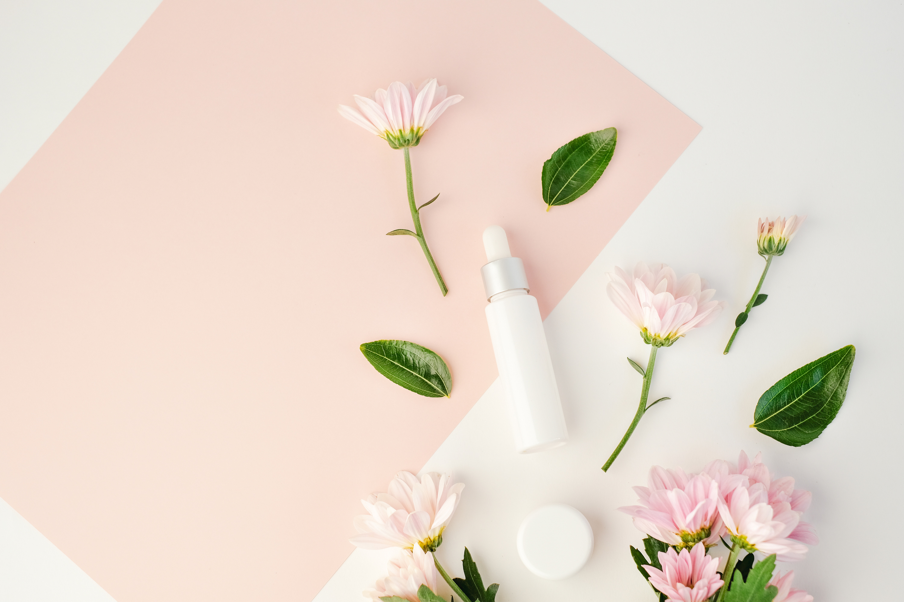 Cosmetic Product with Flowers on White Background